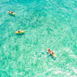 Kayaker paddling along East Oahu coastline