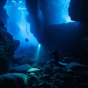 Experienced divers exploring underwater on two tanks