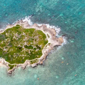 Adventurers riding e-bikes near Popoia Island coastline