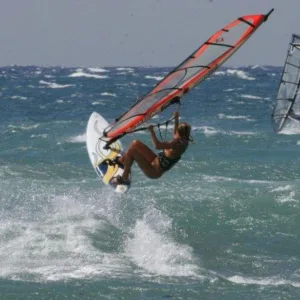 Experienced windsurfers practicing advanced maneuvers on Maui