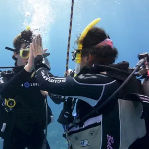 Instructor guiding student during PADI pool dive session