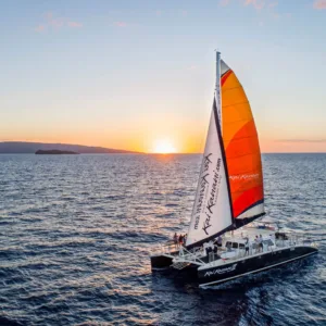 Sailboat gliding during colorful Maui sunset cruise