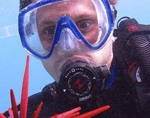 Scuba diver completing open water referral certification in ocean