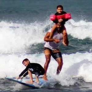 Surf instructor teaching waves on Oahu beach