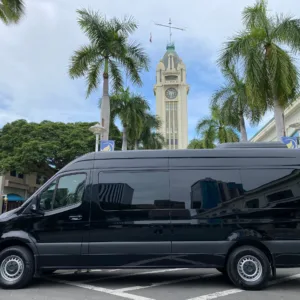 Private boat cruising along Oahu coastline on sunny day