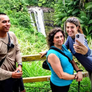 Hikers exploring lush trails near a tropical waterfall