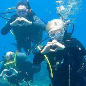 Beginner scuba diver trying on gear before first underwater dive