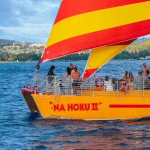 Sailboat cruising at sunset near Kewalo Harbor