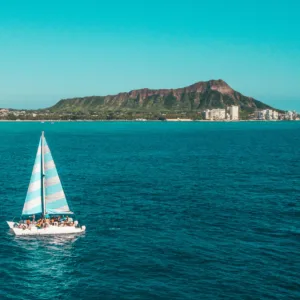 Private charter boat anchored near tropical island shore