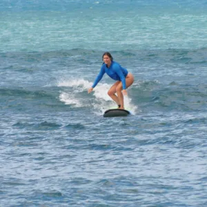 Instructor giving a private surf lesson on a sunny Hawaiian beach