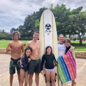 Group enjoying open surf lesson on sunny island beach