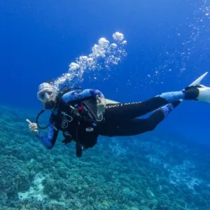 Snorkelers exploring vibrant coral at Molokini Crater Maui