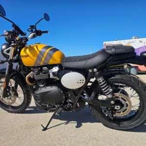 2024 Triumph Scrambler 900 parked on scenic Oahu coastal road