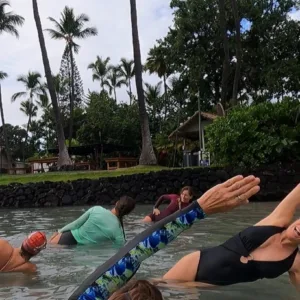 Person practicing yoga on beach with ocean view