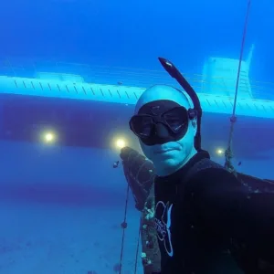 Scuba divers exploring the Carthaginian shipwreck near Mala Pier