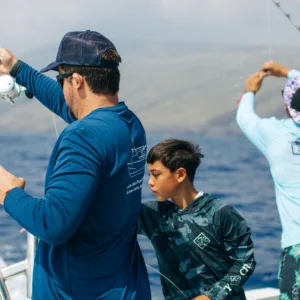 Fisherman casting line during combo fishing and snorkeling trip