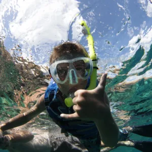 Couple snorkeling in clear Maui ocean waters