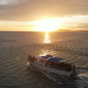 Private luxury cruise boat drifting near Hawaii Kai coastline