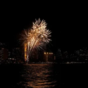 Boat cruising near Waikiki with fireworks in background