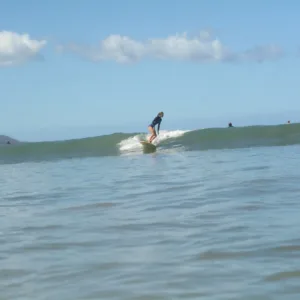 Surfer catching waves during three-day progression course