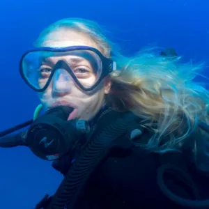 Advanced scuba divers exploring deep ocean environment