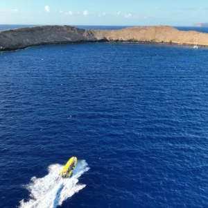Snorkelers swimming above Molokini’s crystal clear waters