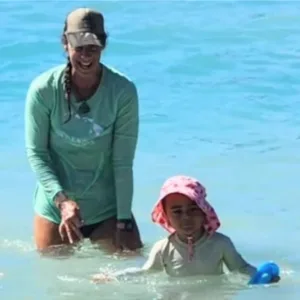 Young child learning to swim in a calm pool setting