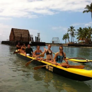 Riding traditional Hawaiian outrigger canoes along Kona coast