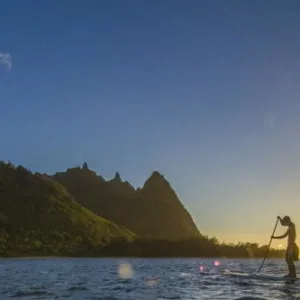 Learning stand up paddleboarding on calm Anini Beach waters