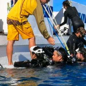 Scuba diver descending into deep water