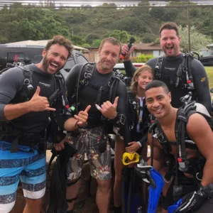 Scuba divers entering ocean from Oahu shore