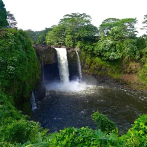 Polaris Slingshot near tropical waterfall in Big Island