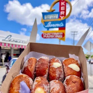 Slingshot vehicle parked near local food trucks