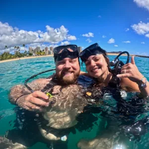 Beginner scuba diver practicing skills in shallow water