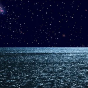 Paddlers in outrigger canoe under starry night sky