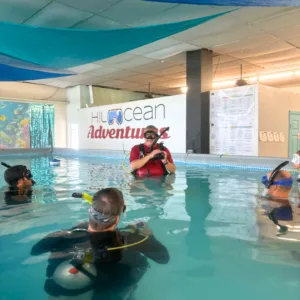 Beginner scuba class in pool with instructor