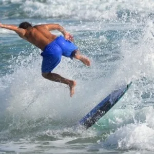 Boogie board lying on sandy beach near ocean