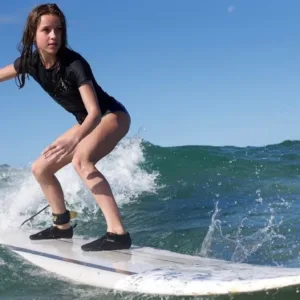 Beginner surfers practicing paddling on calm waves
