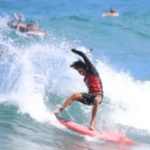Surfer receiving one-on-one coaching on a wave