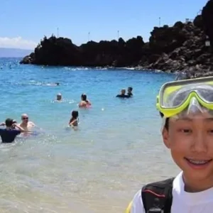 Beginner scuba diver receiving instruction on shore