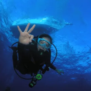 Certified diver preparing for reef dive in ocean
