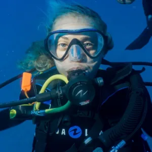 Scuba diver preparing gear for morning dive