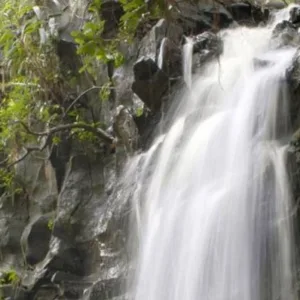 Kayakers paddling along rugged Maui coastline