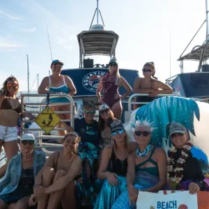 Women divers preparing gear on boat deck