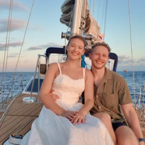 Couple getting married on a private sailboat at sea