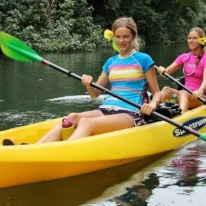 Kayak on Wailua River near lush green trees