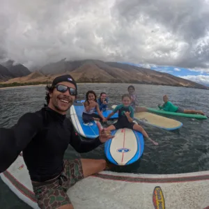 Kids learning to surf in small group lesson