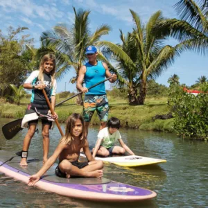 Group of people learning stand-up paddleboarding